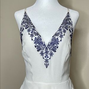 Bebe short white jumpsuit with blue flowers